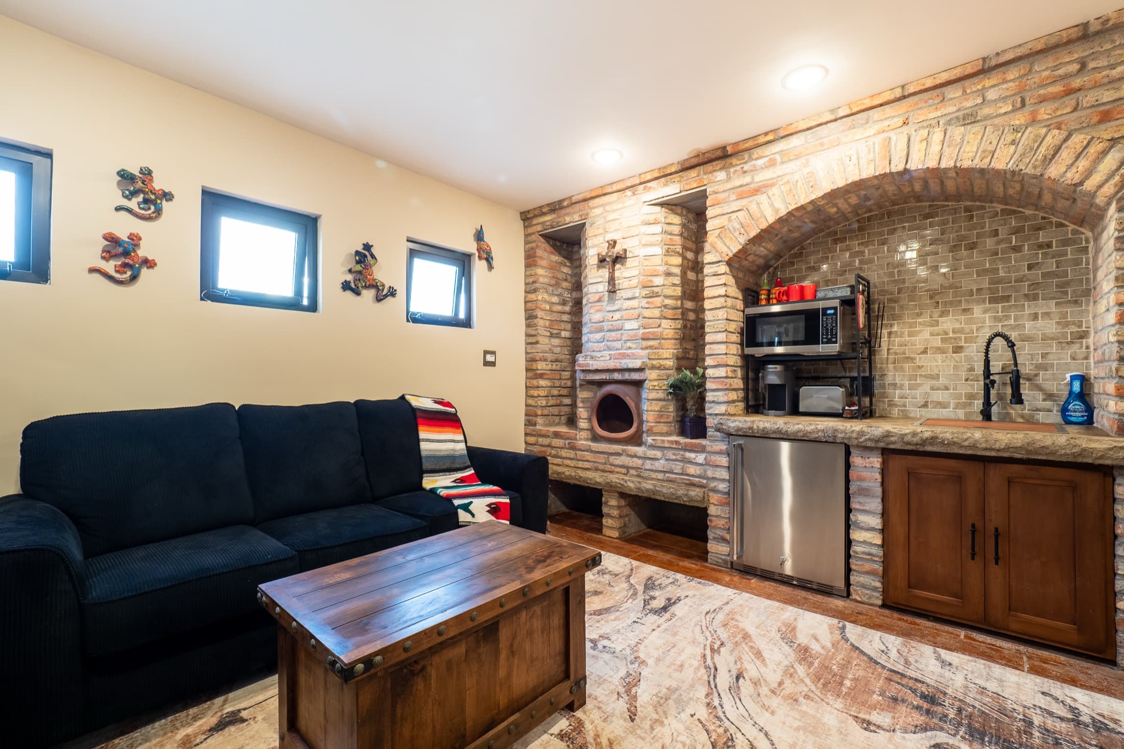 Detached casita interior with brick arch and wet bar