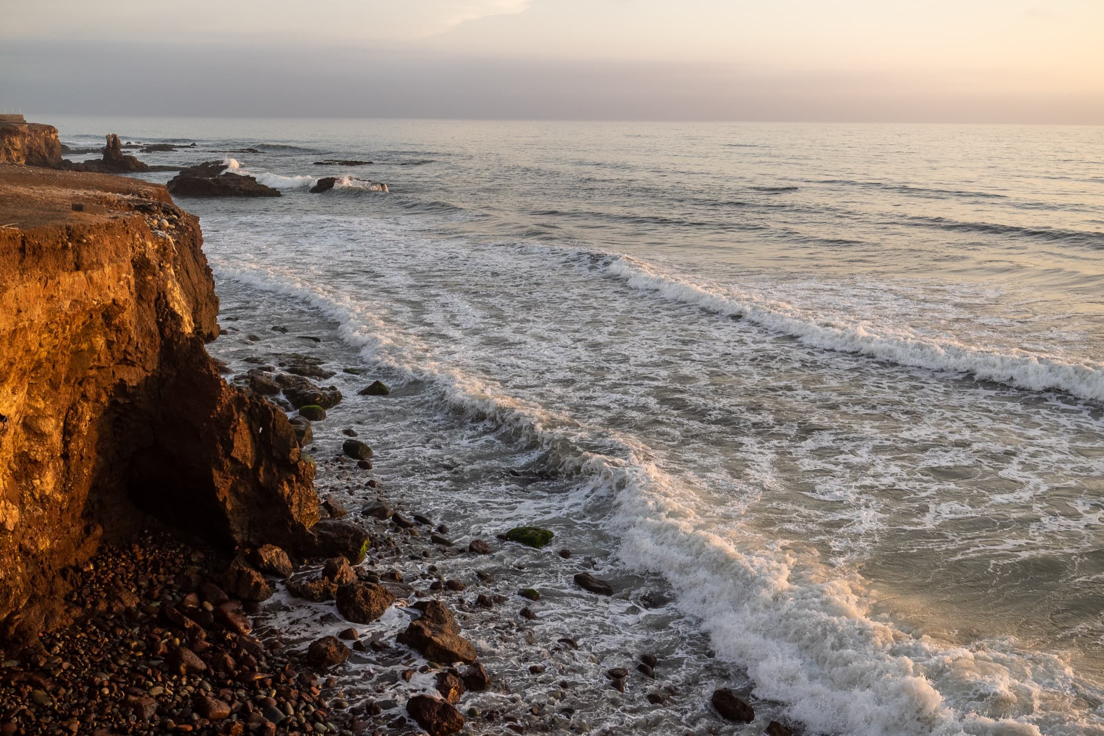 Pacific coastline and surf at sunset