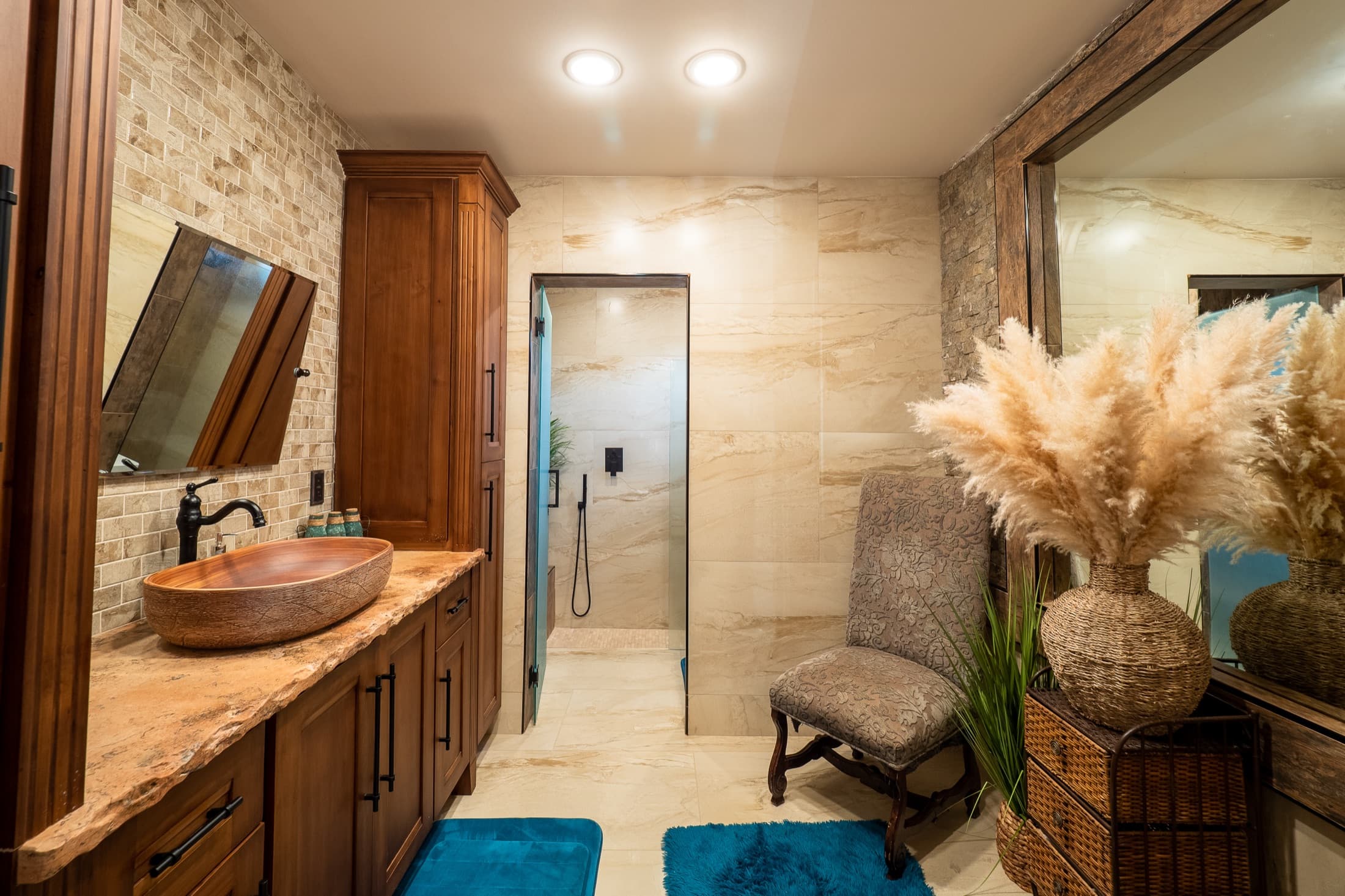 Spa-style bathroom with travertine and a copper vessel sink